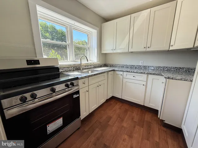 a kitchen with wooden floors and a stove top oven