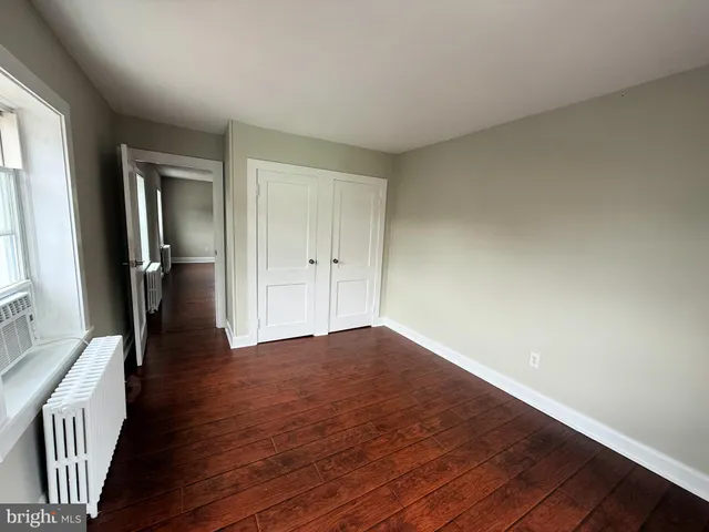 a view of an empty room and wooden floor