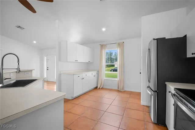 a kitchen with stainless steel appliances a refrigerator sink and stove