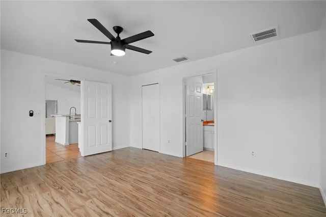 a view of an empty room with wooden floor