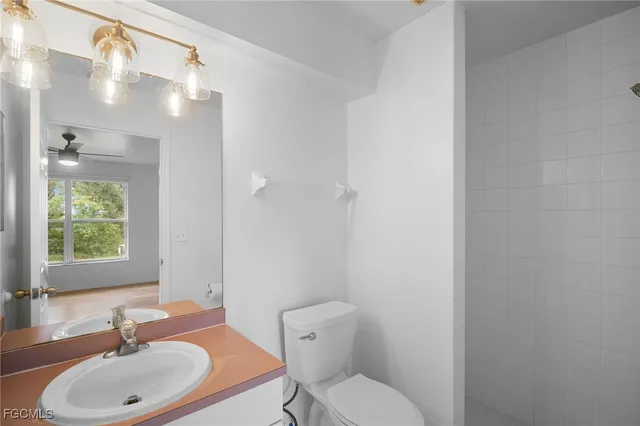 a bathroom with a sink toilet a mirror and shower