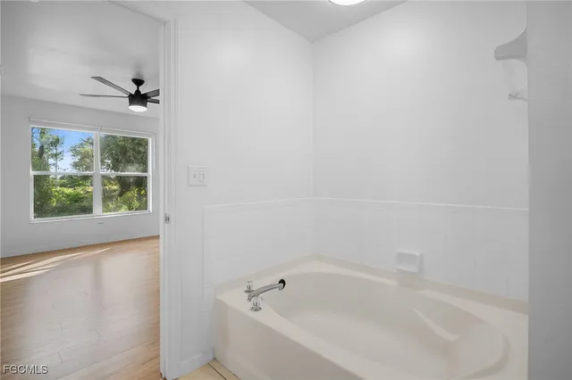 a white bath tub sitting next to a window