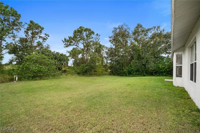 a view of a field with an trees