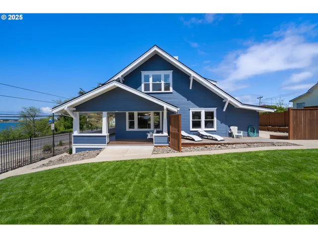 a front view of a house with a garden and patio