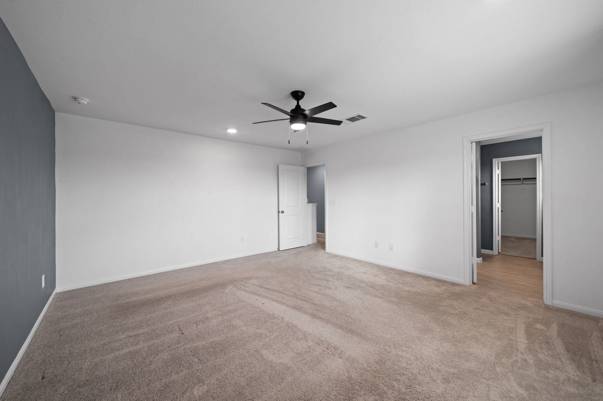 23515 Weir Box Road Hockley, TX 77447 - Photo 12 of 24 a view of an empty room with a ceiling fan