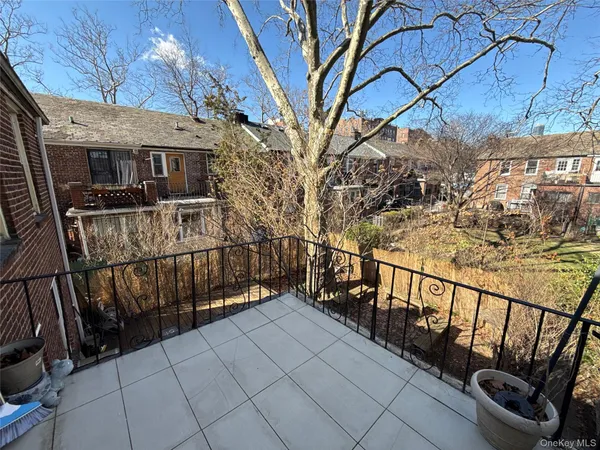 a view of balcony with wooden floor and fence