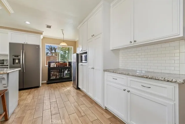 a kitchen with stainless steel appliances a refrigerator and cabinets
