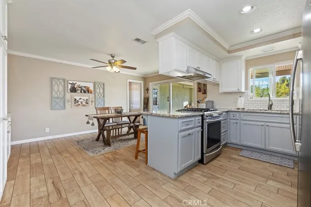 a kitchen with a sink appliances and cabinets