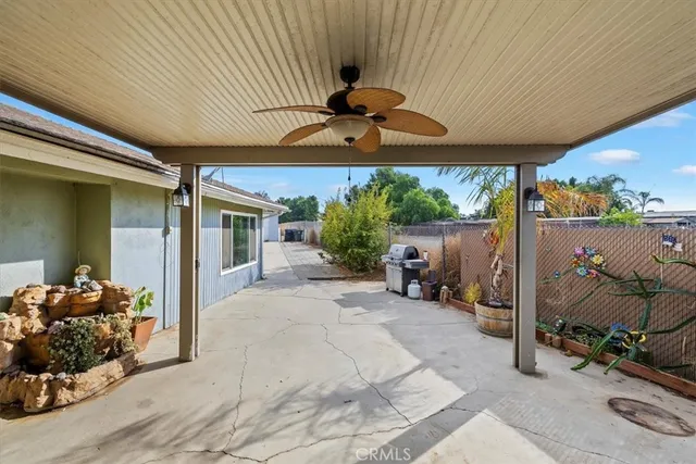 a view of a patio with table and chairs under an umbrella