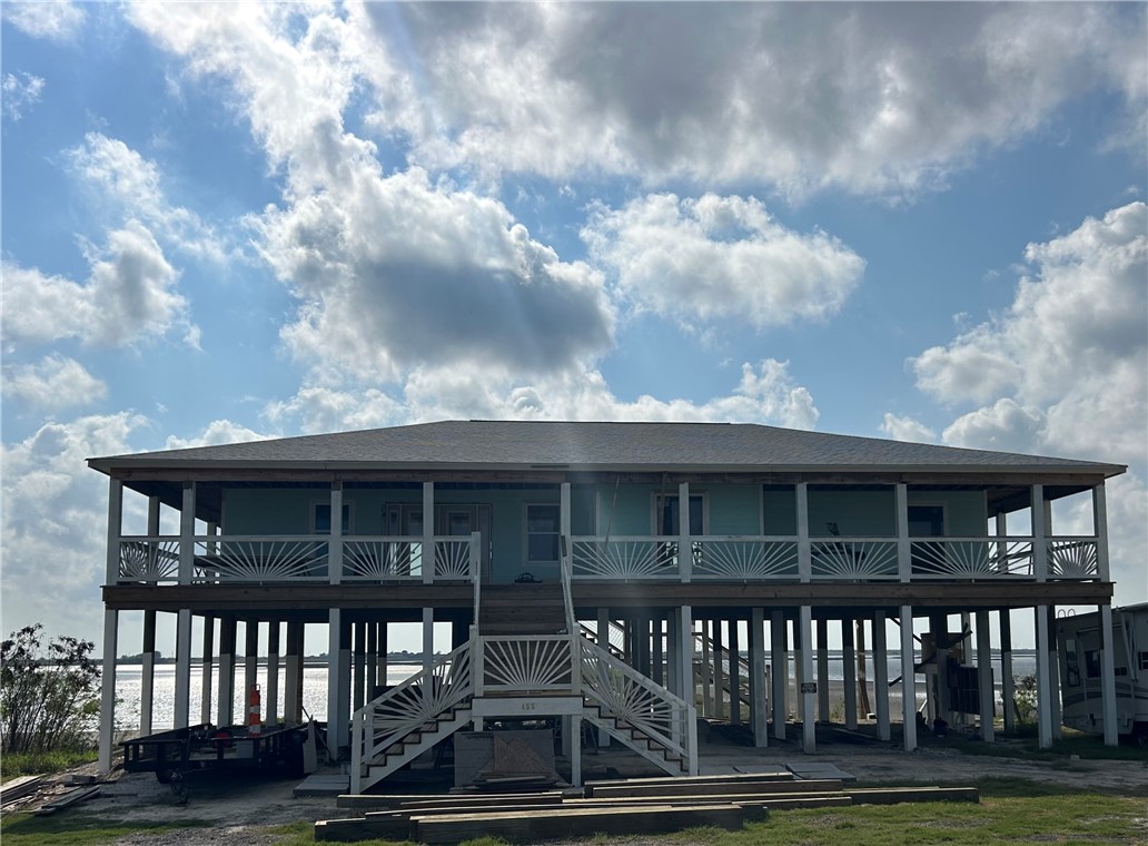 a view of house with a big yard and a garden