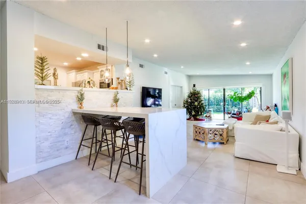 a living room with fireplace furniture and a flat screen tv