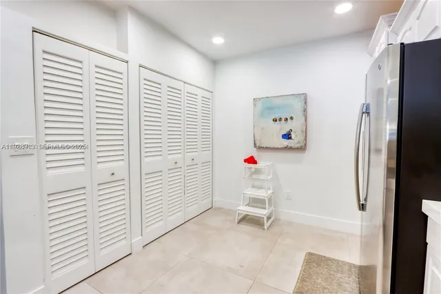 a white cabinet sitting in a kitchen next to a white cabinet