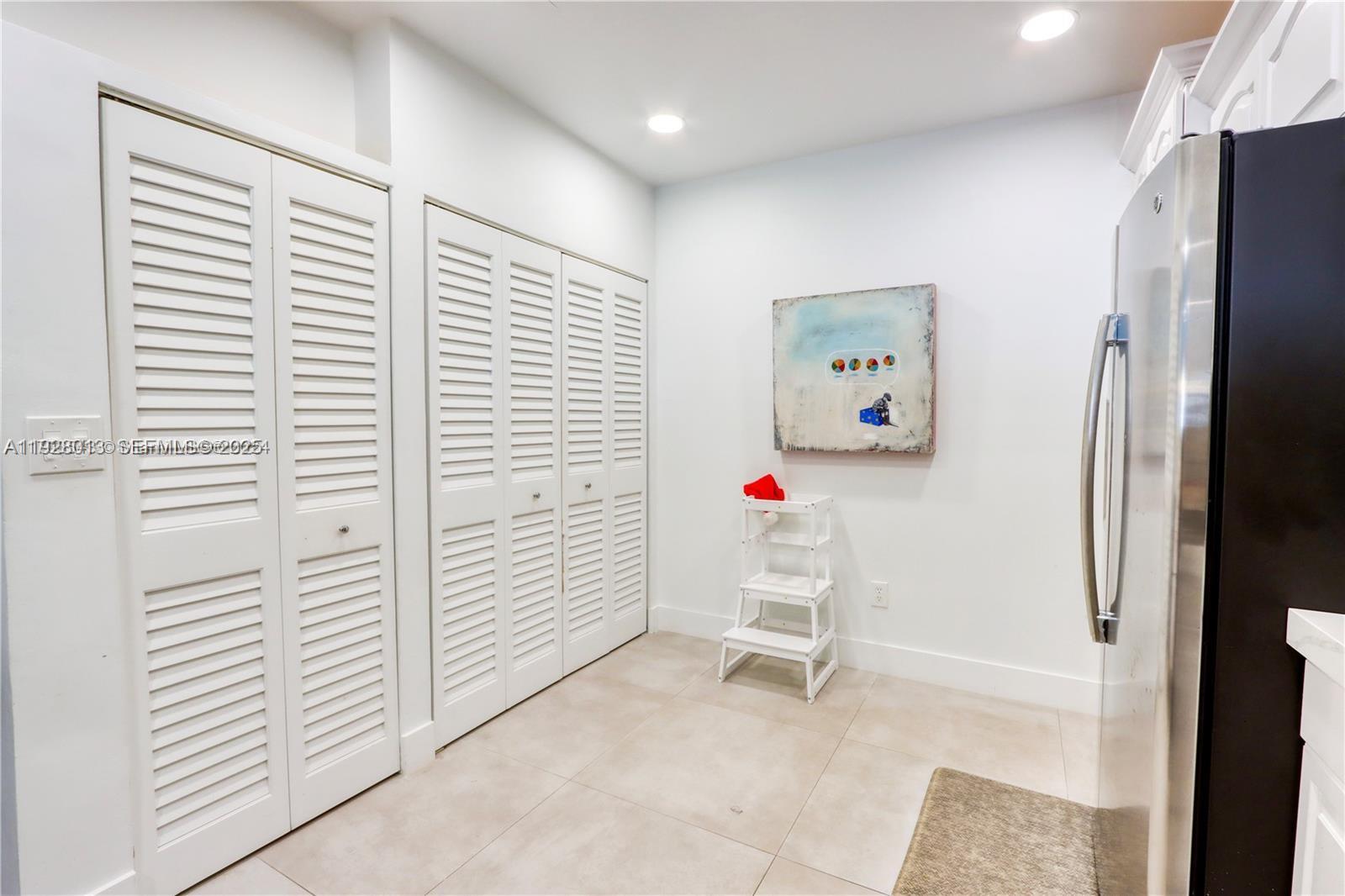 10478 Southwest 75th Lane, Unit 10478 Miami, FL 33173 - Photo 11 of 42 a white cabinet sitting in a kitchen next to a white cabinet
