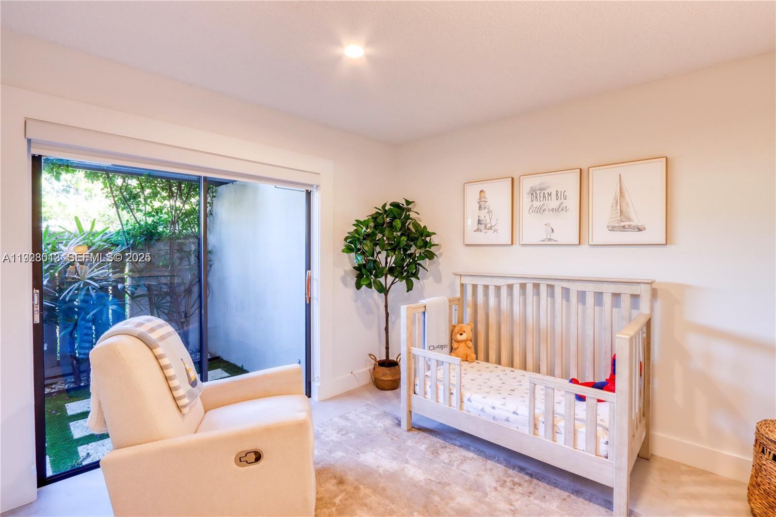 10478 Southwest 75th Lane, Unit 10478 Miami, FL 33173 - Photo 18 of 42 a living room with furniture a door and a potted plant