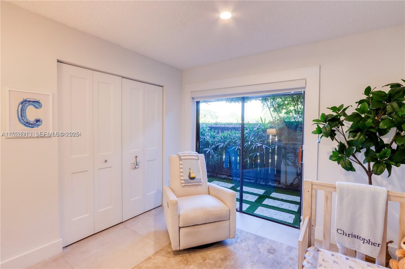 10478 Southwest 75th Lane, Unit 10478 Miami, FL 33173 - Photo 20 of 42 a living room with furniture and a floor to ceiling window