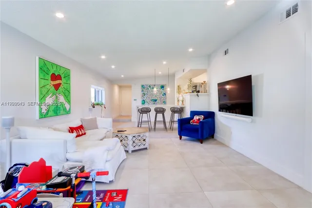 a living room with furniture and flat screen tv