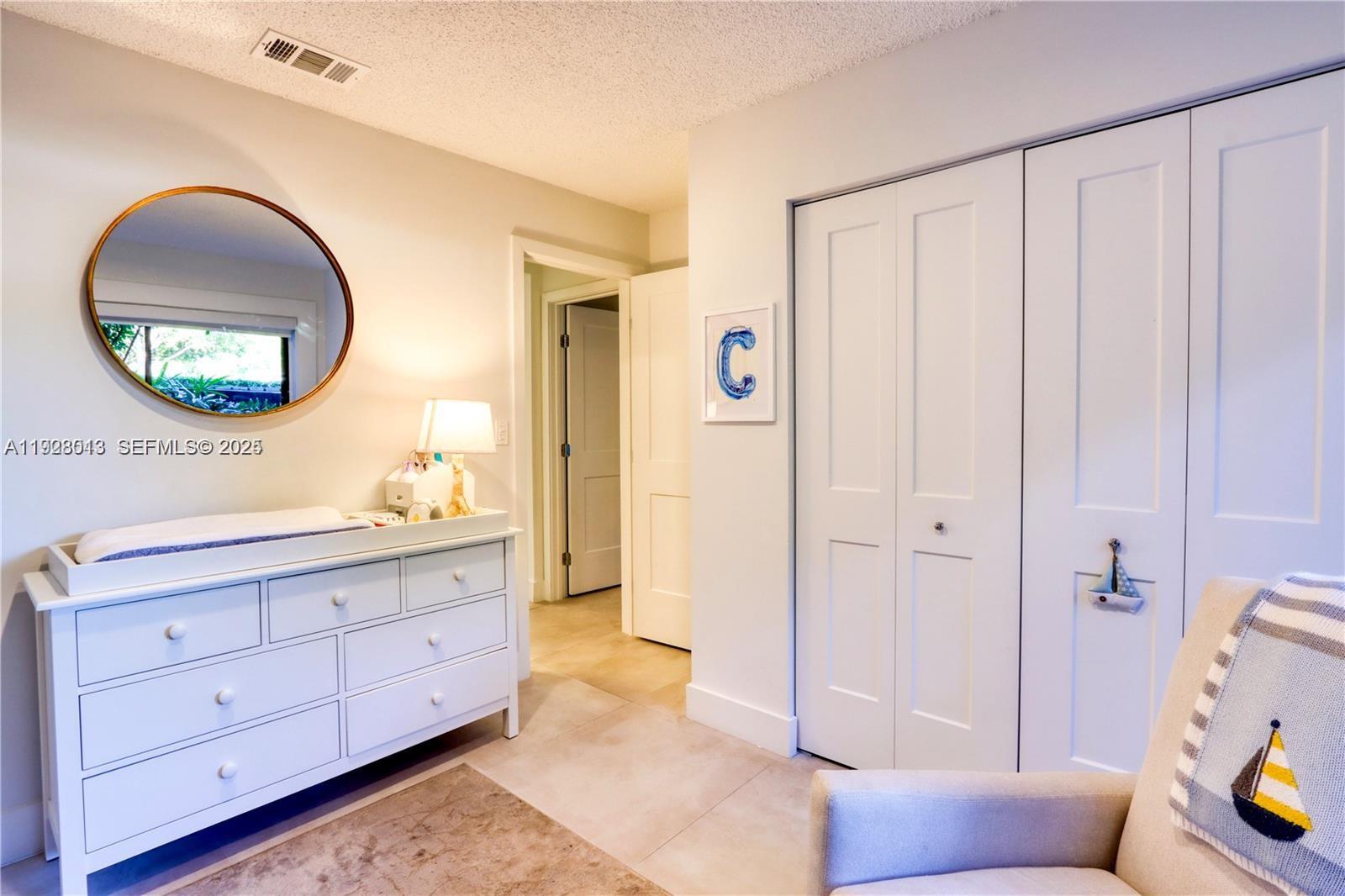 10478 Southwest 75th Lane, Unit 10478 Miami, FL 33173 - Photo 21 of 42 a spacious bathroom with a double vanity sink and a mirror