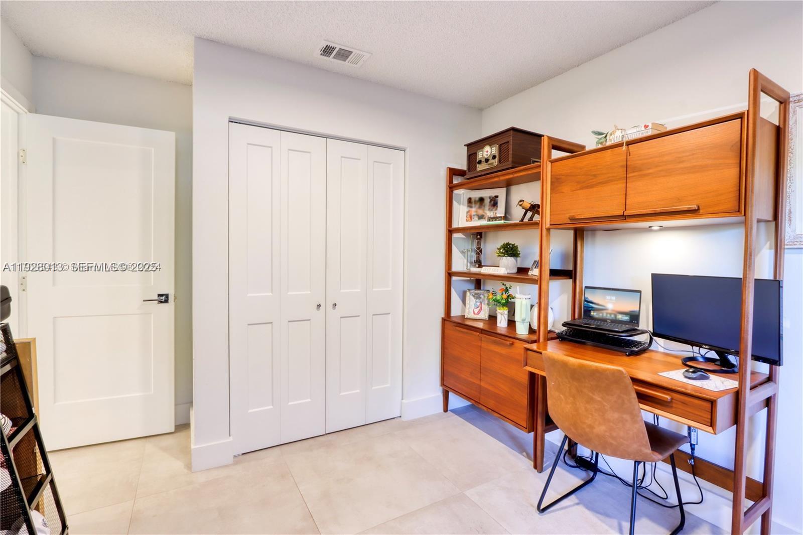 10478 Southwest 75th Lane, Unit 10478 Miami, FL 33173 - Photo 23 of 42 a view of a workspace with furniture