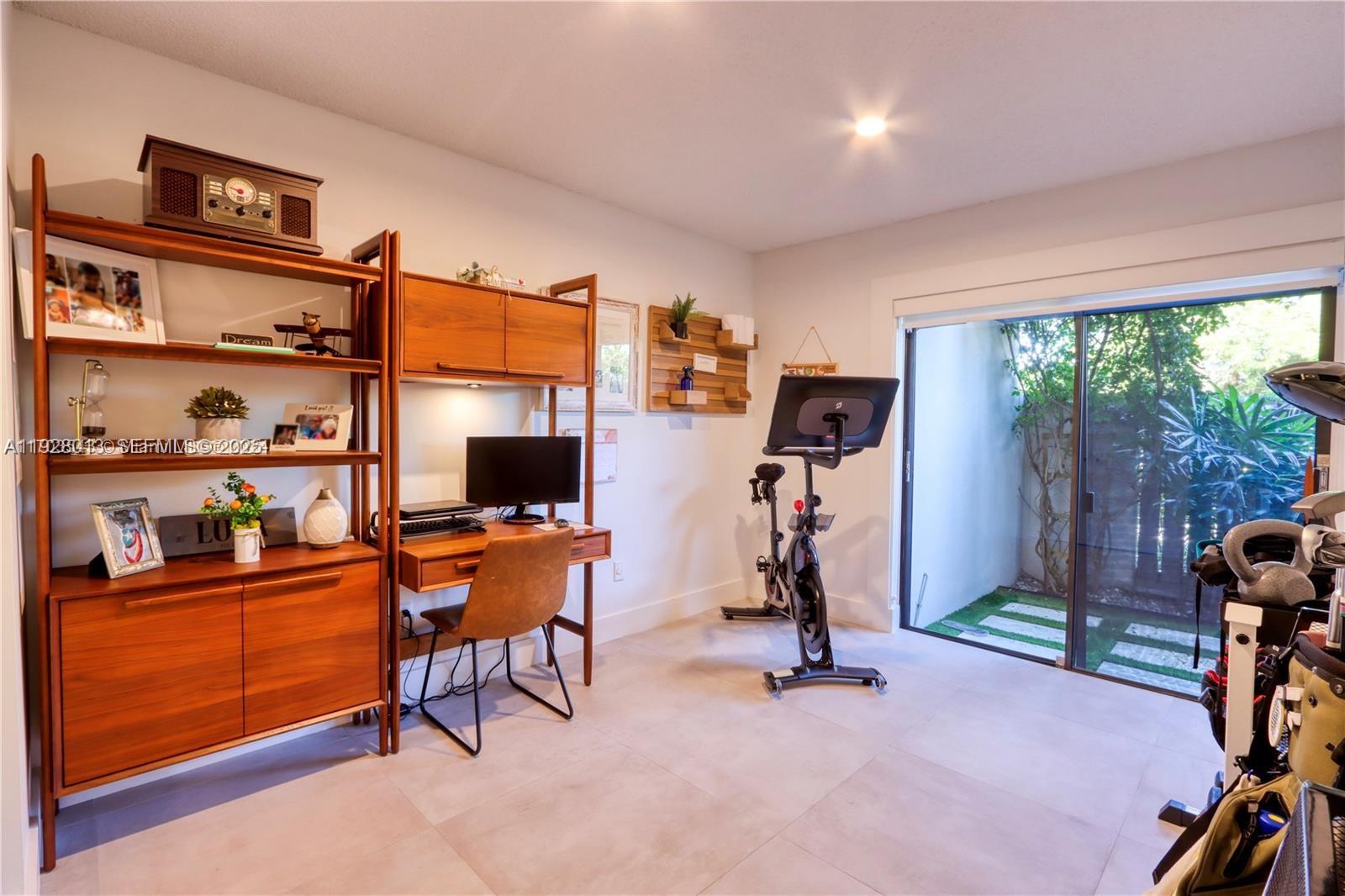 10478 Southwest 75th Lane, Unit 10478 Miami, FL 33173 - Photo 25 of 42 a view of a room with workspace and windows