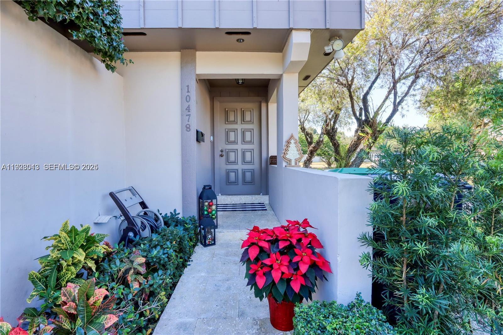 10478 Southwest 75th Lane, Unit 10478 Miami, FL 33173 - Photo 28 of 42 a front view of a house with a yard