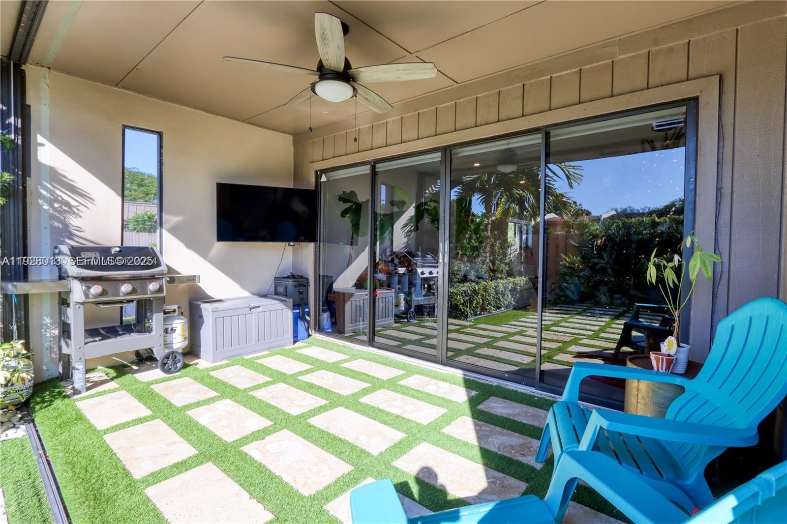 10478 Southwest 75th Lane, Unit 10478 Miami, FL 33173 - Photo 29 of 42 a view of a patio with a dining table and chairs