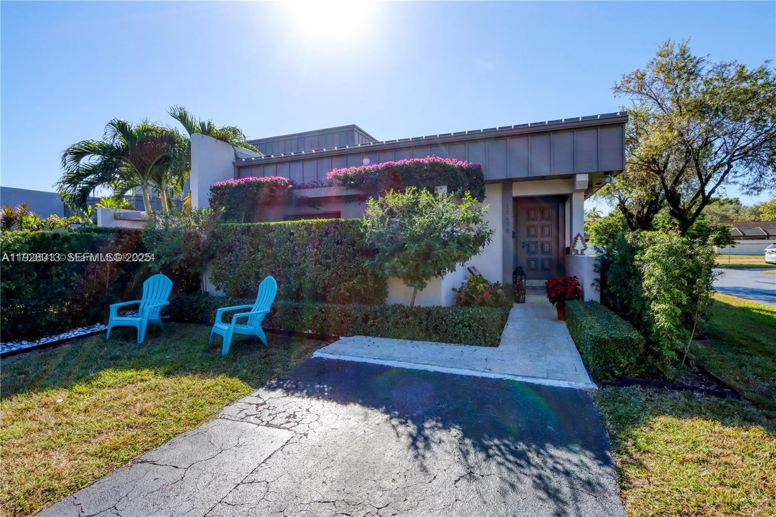 10478 Southwest 75th Lane, Unit 10478 Miami, FL 33173 - Photo 30 of 42 a view of a house with a yard and sitting area