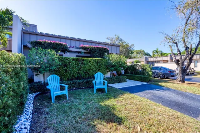 a backyard of a house with outdoor seating