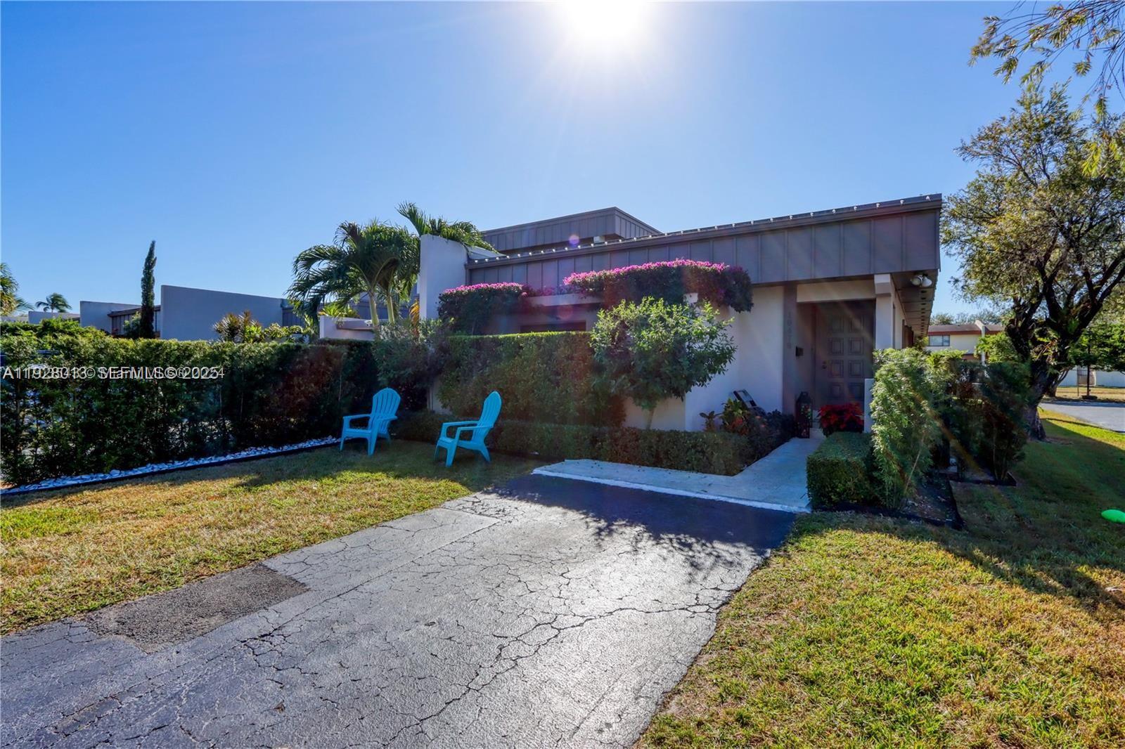 10478 Southwest 75th Lane, Unit 10478 Miami, FL 33173 - Photo 32 of 42 a view of a house with a yard and plants
