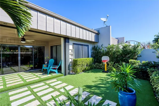 a view of a house with backyard porch and sitting area
