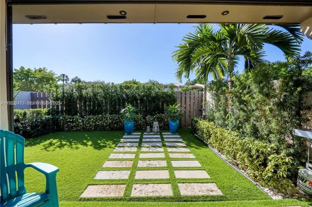 a view of backyard with swimming pool and green space