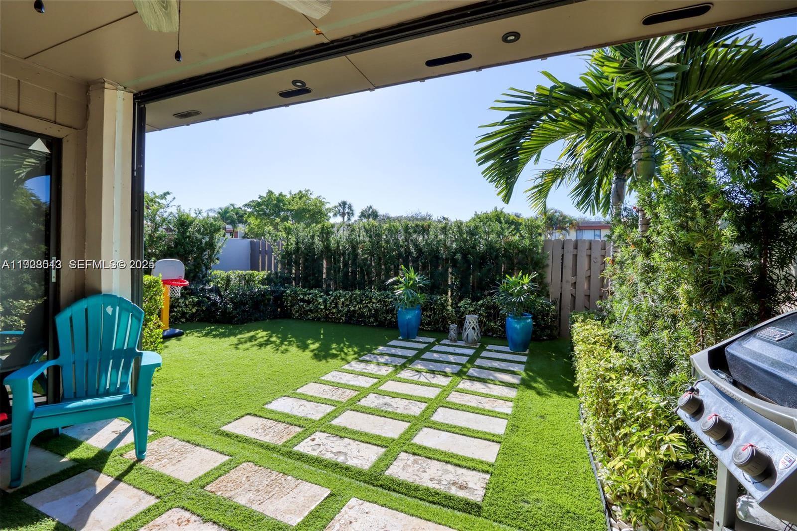 10478 Southwest 75th Lane, Unit 10478 Miami, FL 33173 - Photo 36 of 42 a view of backyard with a table and a chairs