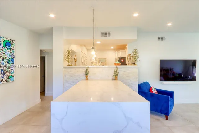 a large bedroom with a bed and a flat screen tv