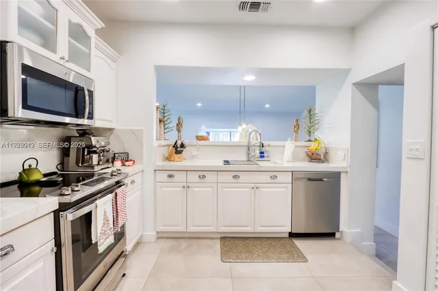 a kitchen with stainless steel appliances granite countertop a sink and a stove