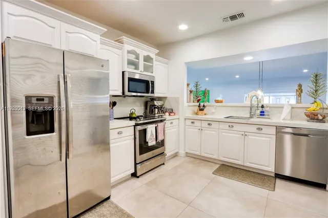 a kitchen with cabinets and stainless steel appliances