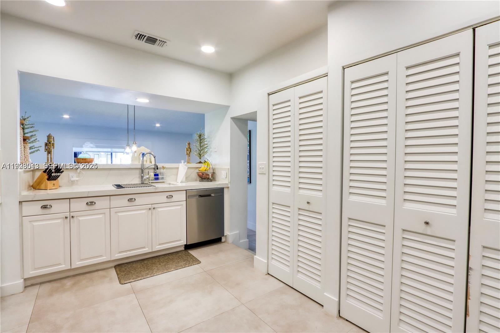 10478 Southwest 75th Lane, Unit 10478 Miami, FL 33173 - Photo 10 of 42 a bathroom with a sink a vanity and a mirror