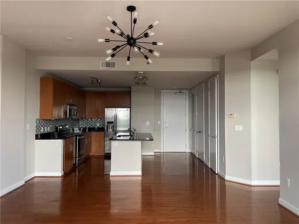a view of a kitchen with a sink stainless steel appliances and cabinets