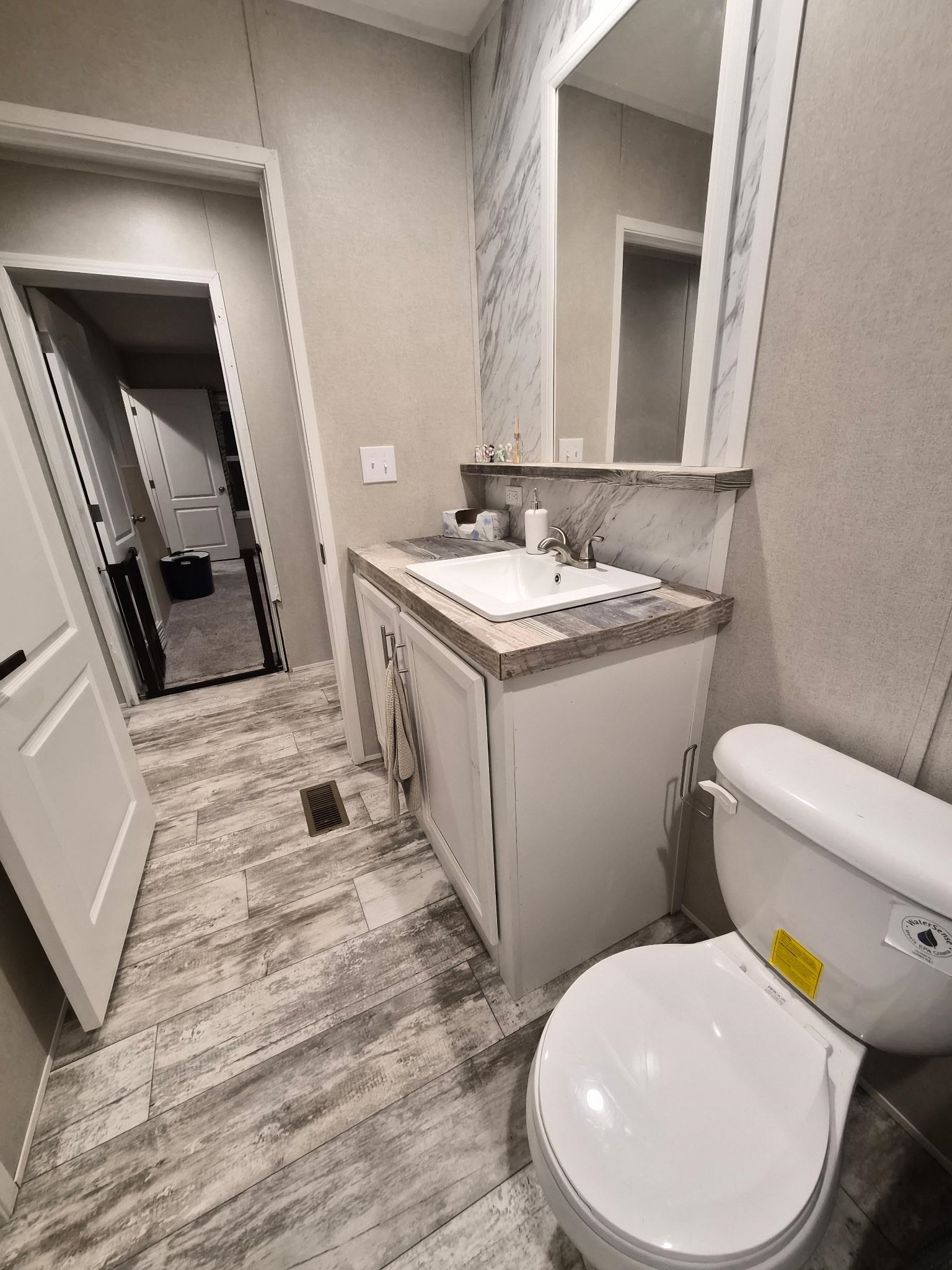 510 Potts Chapel Road Jackson, TN 38305 - Photo 26 of 30 Half bath featuring vanity and a textured wall
