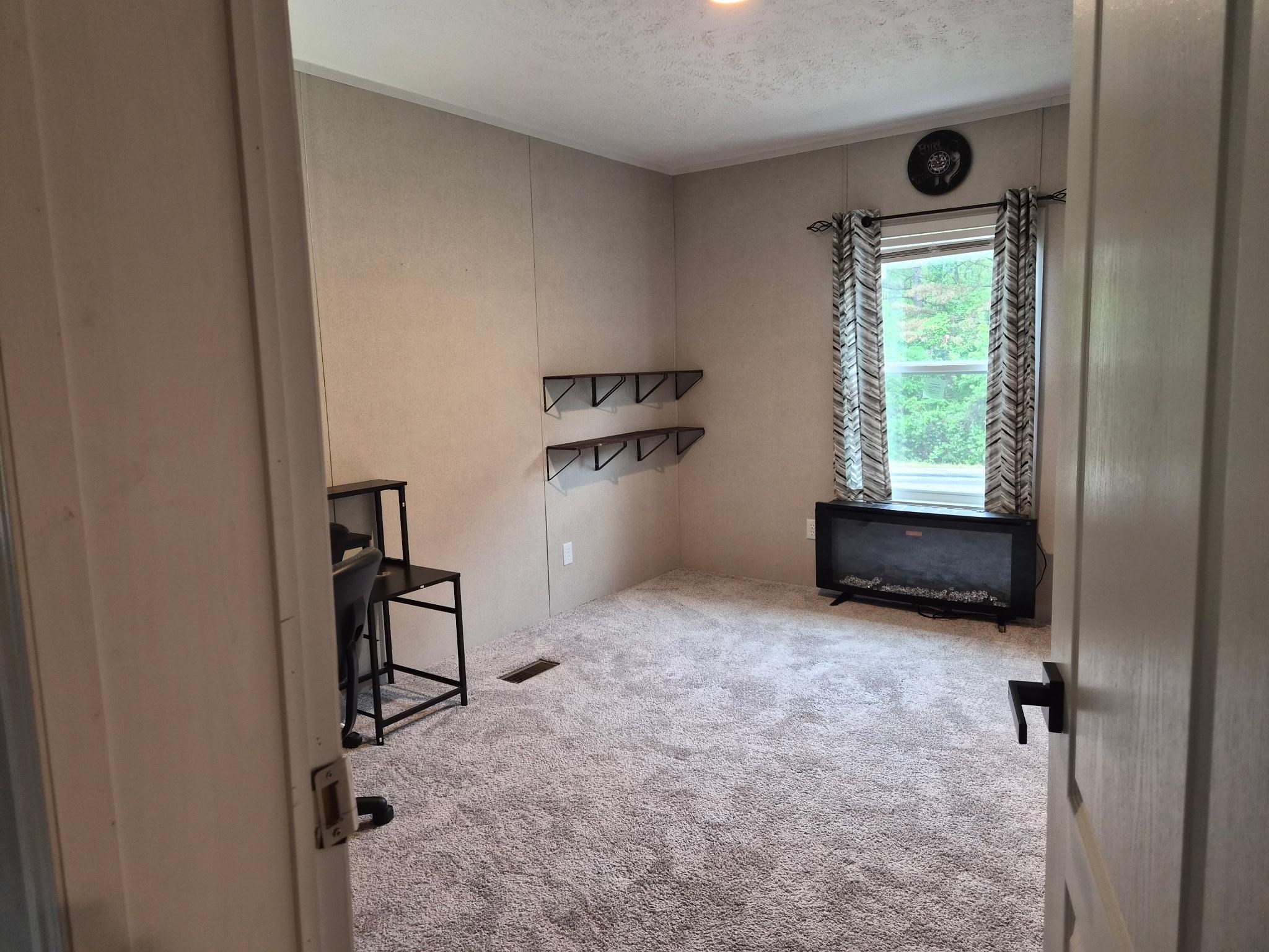 510 Potts Chapel Road Jackson, TN 38305 - Photo 27 of 30 Unfurnished office featuring light colored carpet and a textured ceiling