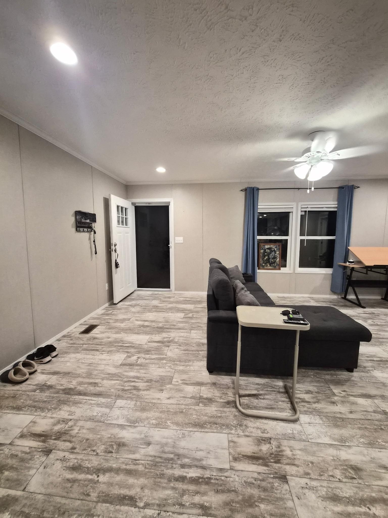 510 Potts Chapel Road Jackson, TN 38305 - Photo 5 of 30 Living area with light wood-type flooring, recessed lighting, a ceiling fan, and a textured ceiling