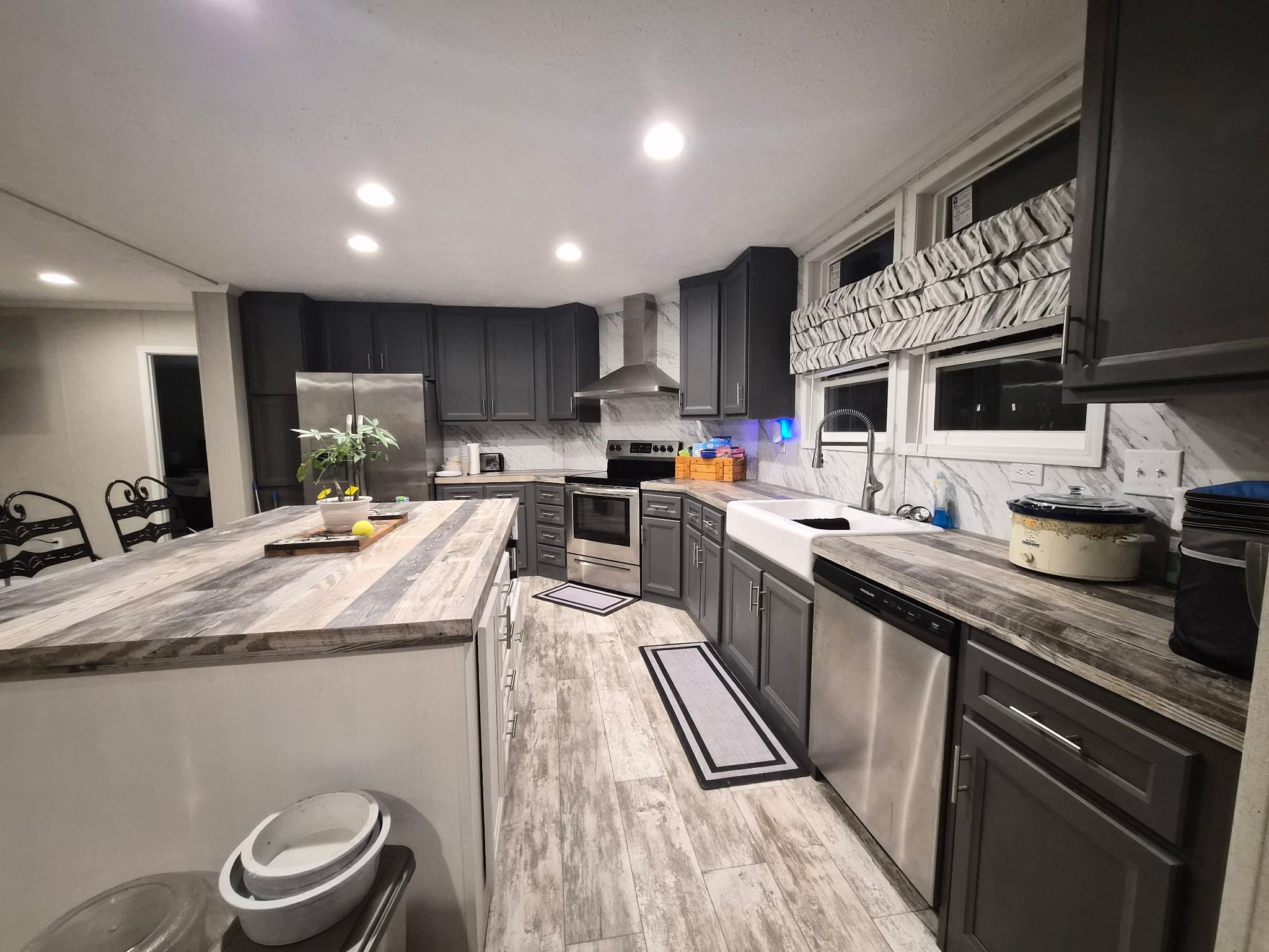 510 Potts Chapel Road Jackson, TN 38305 - Photo 10 of 30 Kitchen with wooden counters, stainless steel appliances, backsplash, a kitchen island, and light wood finished floors