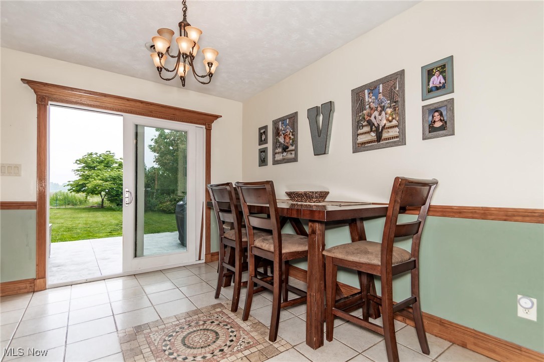 5081 Middle Ridge Road Perry, OH 44081 - Photo 6 of 33 Dining space with baseboards, a chandelier, and tile flooring