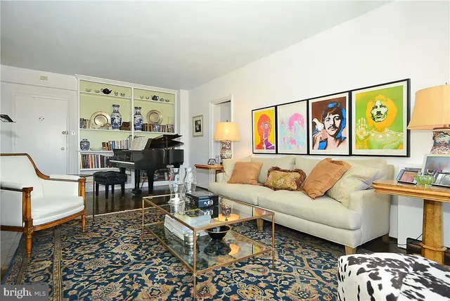 a living room with furniture and painting on the wall