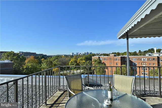 a view of a balcony with wooden floor and outdoor seating