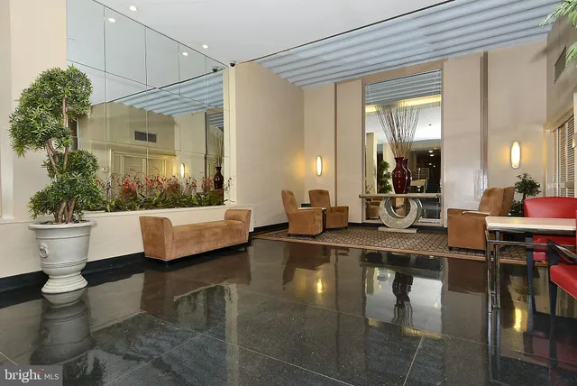 a living room with patio furniture and a large window