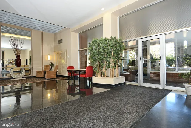 a lobby with furniture and floor to ceiling window