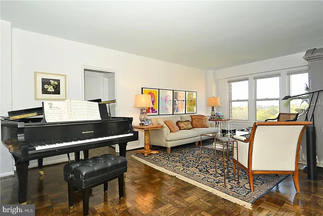 a living room with furniture a rug and a window