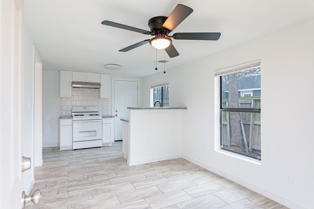 a view of kitchen with center island and stainless steel appliances