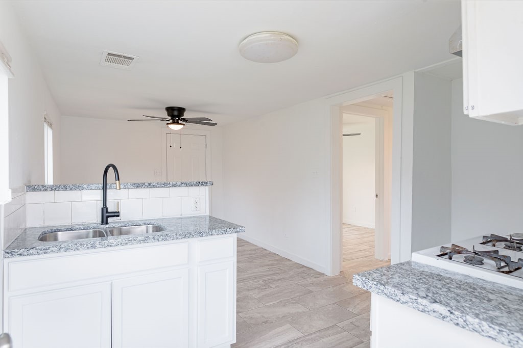 1307 Boulder Street Houston, TX 77012 - Photo 9 of 14 a bathroom with a granite countertop sink and a mirror