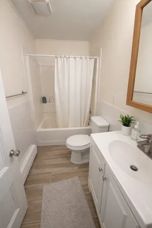 a bathroom with a double vanity sink toilet and shower