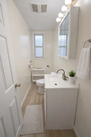 a bathroom with a sink toilet and shower